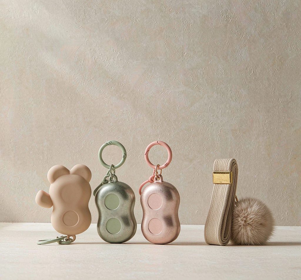 Metal keychains, woven lanyards and fur ball bag charms